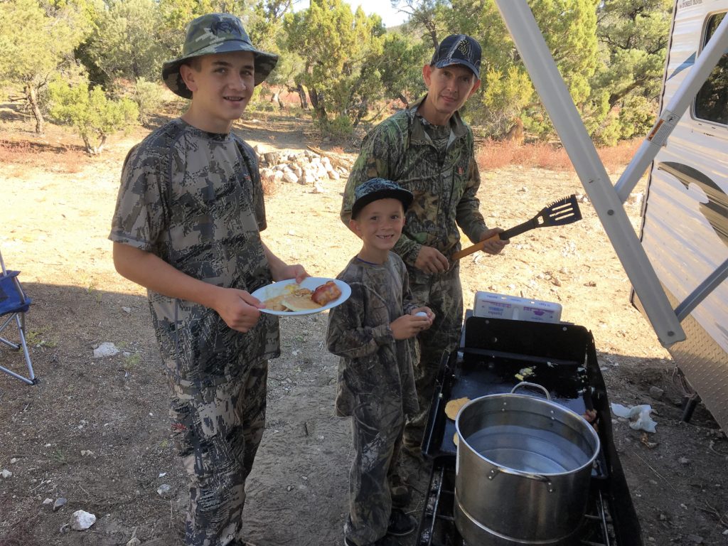 Sons enjoy breakfast at camp